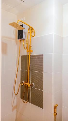 a shower in a bathroom with a shower head at Palacio in Kaybagal