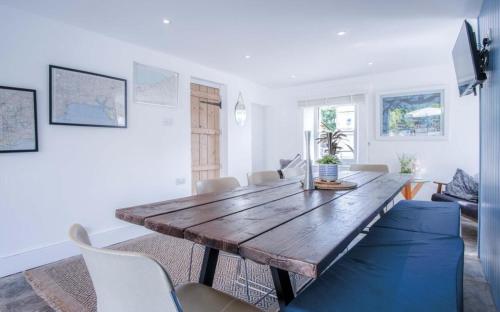 a living room with a wooden table and chairs at Angle Adventures - sleeps 8 in Angle