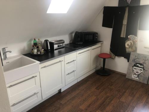 a kitchen with a sink and a counter top at Bel Art Atelier mit großem Parkplatz in Haan
