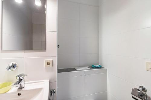 a white bathroom with a sink and a mirror at The view 2 in Bad Reichenhall
