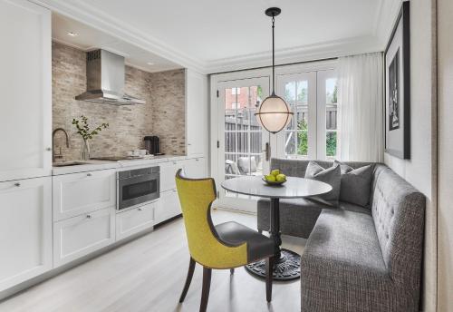 a kitchen and living room with a couch and a table at Rosewood Washington DC in Washington