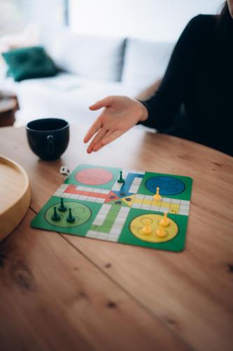 a person playing a board game on a table at Charszówka in Kobrzyniec Stary