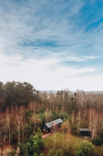 an aerial view of a barn in a forest at Charszówka in Kobrzyniec Stary