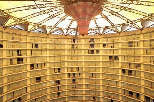 a large building with many windows and a ceiling at Rajhans belliza in Surat
