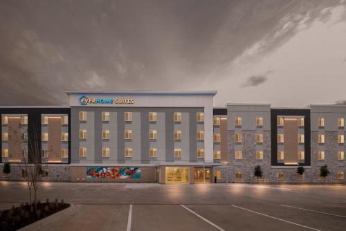 a large building with a sign on the front of it at Everhome Suites Bastrop in Bastrop