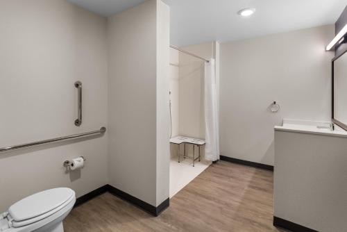 a bathroom with a toilet and a sink at Everhome Suites Bastrop in Bastrop