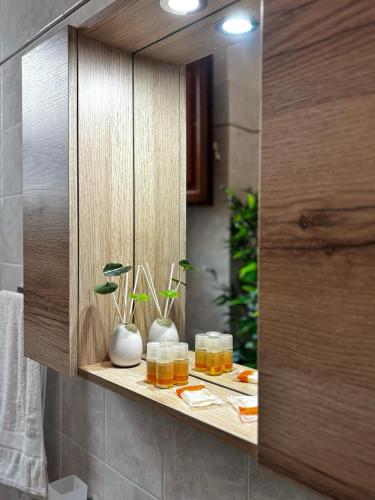 a shelf in a bathroom with jars and plants at B&B Conte Umberto Salemi in Salemi