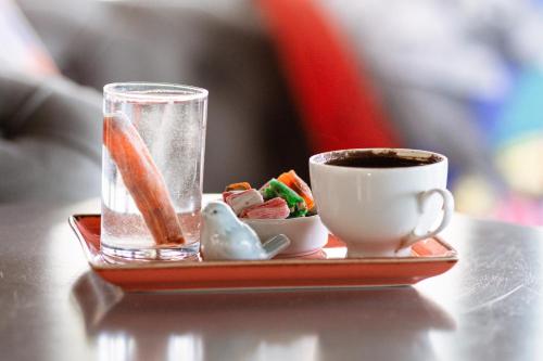 a tray with a cup of coffee and a plate of food at Mare Garden Hotel in Akyarlar