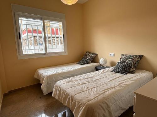 Ένα ή περισσότερα κρεβάτια σε δωμάτιο στο Casa Aluse Beach by SunshineClub