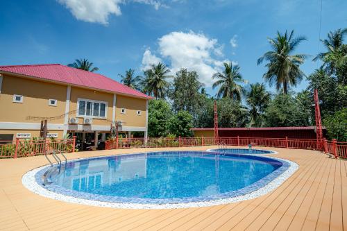 a large swimming pool in front of a house at Queen Island Kampot in Kampot