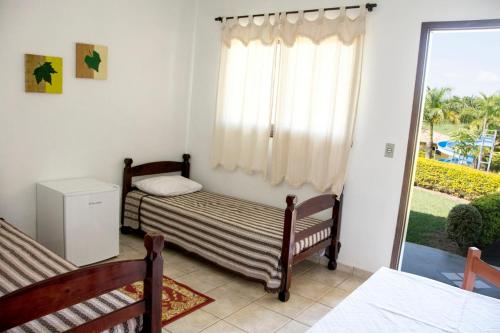 Postel nebo postele na pokoji v ubytování Hotel Fazenda Monte Sião