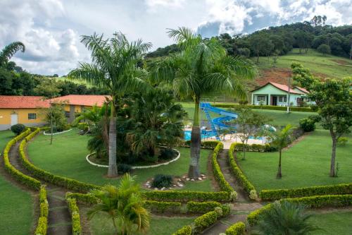 Hotel Fazenda Monte Sião في مونتي سيو: اطلالة جوية على منتجع فيه مسبح و نخيل