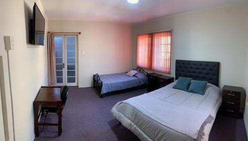 Ένα ή περισσότερα κρεβάτια σε δωμάτιο στο Habitaciones privadas en Centro de La Paz