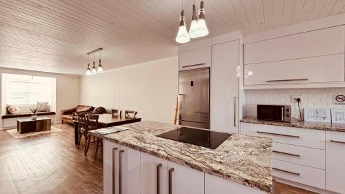 a kitchen with white cabinets and a counter top at Nautilus 2 bedroom self-catering apartment in Swakopmund