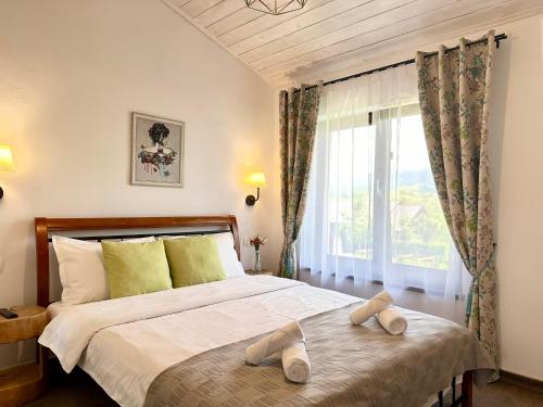 a bedroom with a bed with two slippers on it at EPIC HOUSE Valea Avrigului in Avrig