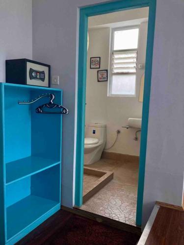 a bathroom with a blue cabinet and a toilet at MayaTels - Maya Baas, Rumtek in Gangtok