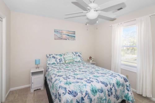 a bedroom with a bed and a ceiling fan at Saltwater - Pet friendly, Waterfront! in Black Point Landing