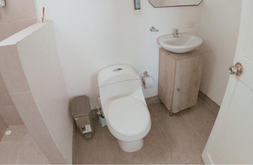 a small bathroom with a toilet and a sink at Quinta del Mar Crystal Beach in Tintipan Island