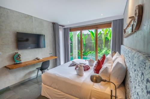a hotel room with a bed and a window at Ubud Diary Villa in Ubud