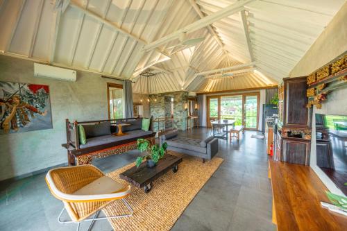 a living room with a couch and a table at Ubud Diary Villa in Ubud