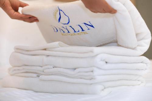 a stack of white towels on a bed at Daylin Guest House in Addis Ababa