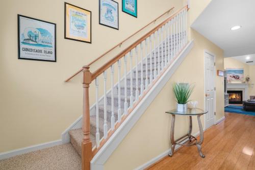 a staircase in a home with a table at Sea La Vie - Duplex, Shared pool! in Chincoteague