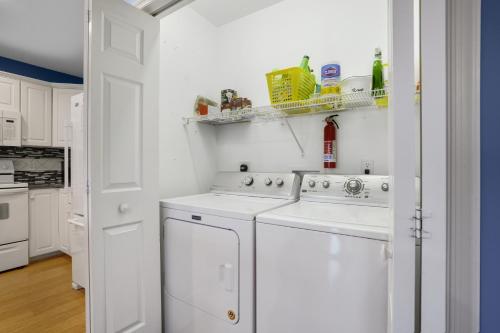 a white laundry room with a washer and dryer at Sea La Vie - Duplex, Shared pool! in Chincoteague