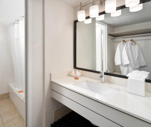 a bathroom with a sink and a mirror at Wyndham I-Drive Avanti Resort & Conference Center in Orlando