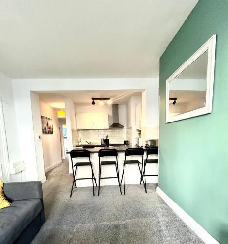 a living room with a couch and a kitchen at Town Centre Apartments by the Beach, BIC, Pavilion in Bournemouth