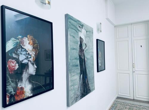 a large painting of a woman on a wall at Stylish Boutique Duplex Apartment Home - Green - 2 Large Double Bedrooms with Ensuite Bathrooms in Msida
