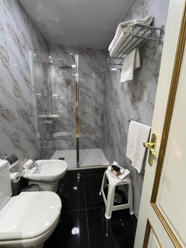 a bathroom with a sink and a toilet and a shower at Adriano Boutique Sevilla in Seville