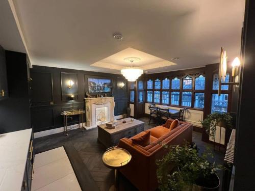 a living room with a couch and a fireplace at Exquisite City Centre Apartment in Chester