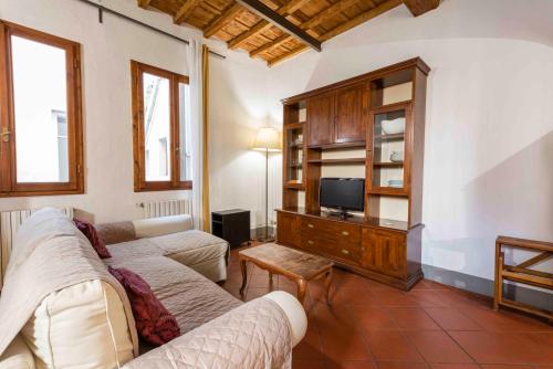 a living room with two couches and a tv at Borgo Allegri Palace By MMega in Florence