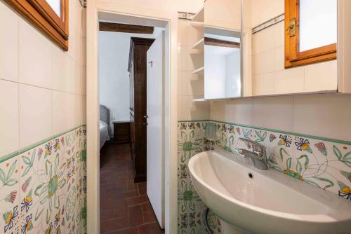 a bathroom with a sink and a mirror at Borgo Allegri Palace By MMega in Florence