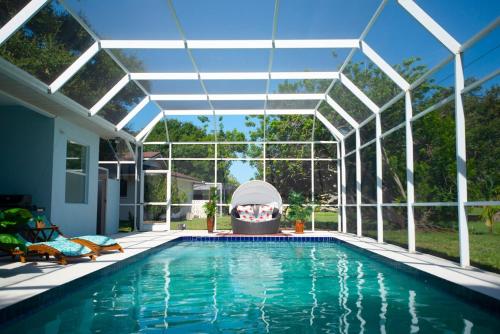 an indoor swimming pool with a pergola and a swimming poolvisor at Huge home w pool Siesta Key and Anna Maria in Sarasota