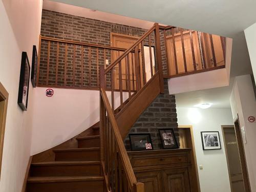 a staircase in a house with a brick wall at Les Scailletons à Neufchâteau - Ardenne Belge in Neufchâteau