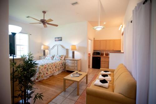 a bedroom with a bed and a couch and a table at Huge home w pool Siesta Key and Anna Maria in Sarasota