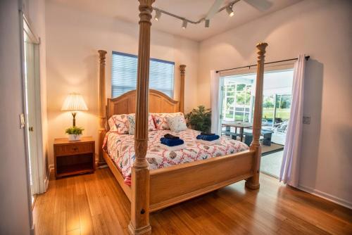 a bedroom with a four poster bed in a room at Huge home w pool Siesta Key and Anna Maria in Sarasota