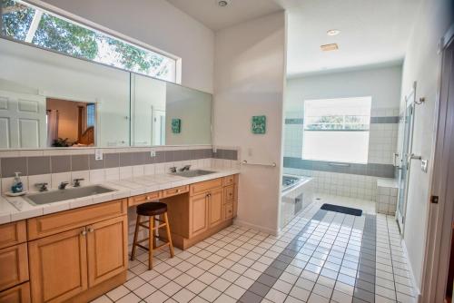 a bathroom with a double sink and a shower at Huge home w pool Siesta Key and Anna Maria in Sarasota