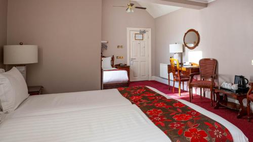 a hotel room with a bed with a red floral rug at Harrington Hall in Dublin