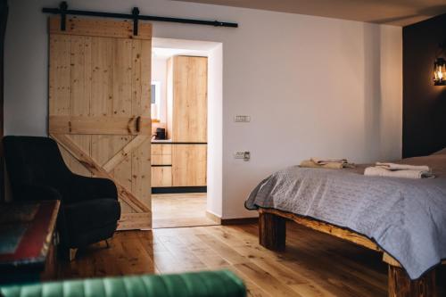a bedroom with a bed and a sliding door at Daheim in Râşnov