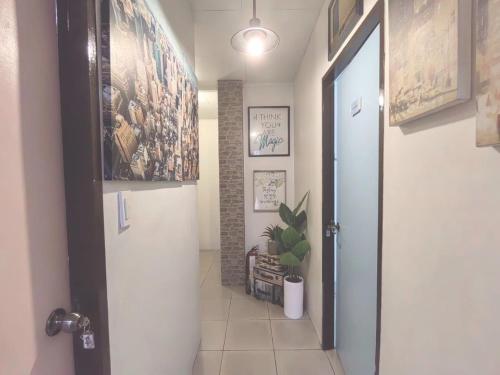 a hallway with a door and a plant in a room at Nappers Hostel in Cebu City