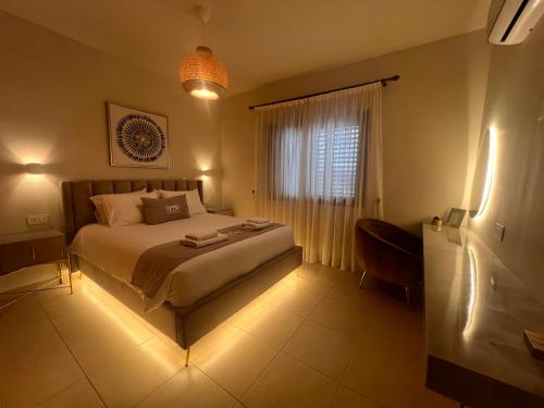 a bedroom with a bed and a window with lights at Matteo Villa Limassol Cyprus in Limassol