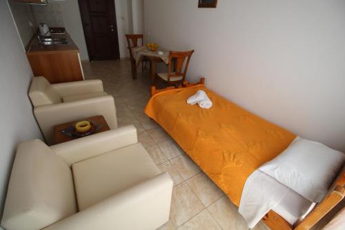 a living room with a bed and a couch at Zorbas studio deluxe in Moraitika