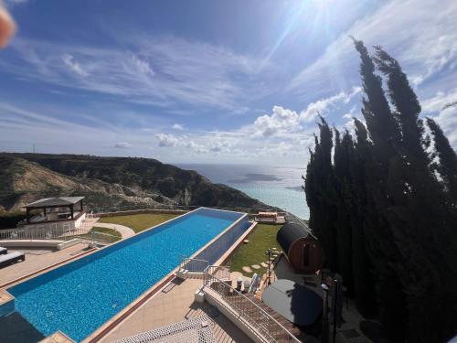 a swimming pool with a view of the ocean at Matteo Villa Limassol Cyprus in Limassol