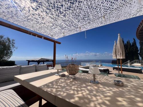 a table with chairs and a view of the ocean at Matteo Villa Limassol Cyprus in Limassol