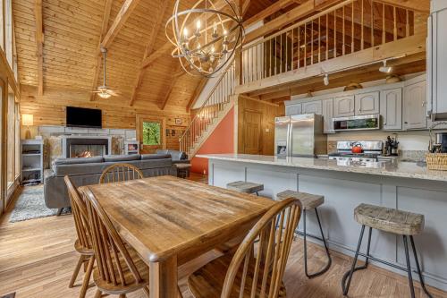 a kitchen and dining room with a wooden table and chairs at Red Wolf by Carolina Mornings in Fletcher