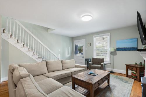 a living room with a couch and a table at Seaside - Traditional duplex in historic downtown! in Cape Charles