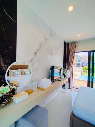 a living room with a mirror and a bed at Relax Pool Villa Khaoyai - รีแล็กซ์พูลวิลล่าเขาใหญ่ in Ban Bung Toei