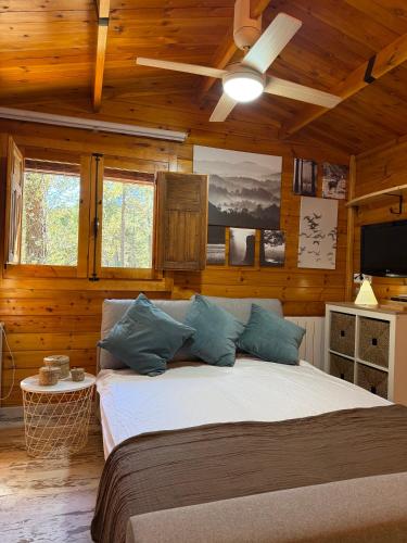 a bedroom with a large bed in a wooden room at Casa Rural Mi Camino in Riópar